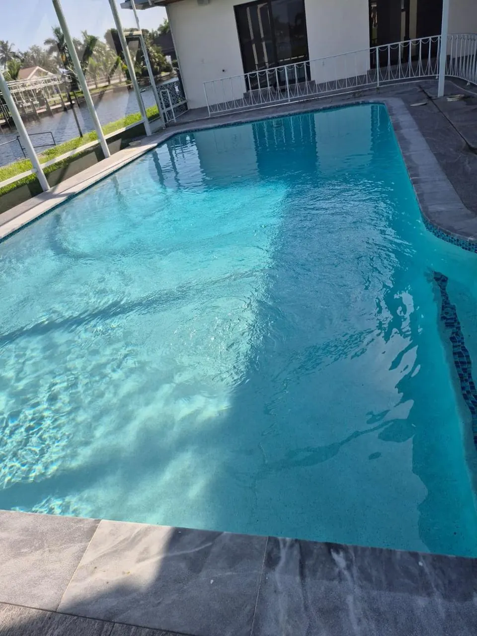 Waterfront pool with clear blue water