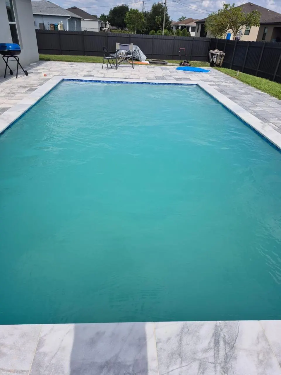 The same pool after service: clear teal water